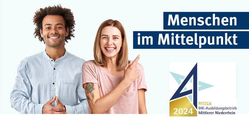 Zwei Personen, eine zeigt auf den Slogan Menschen im Mittelpunkt