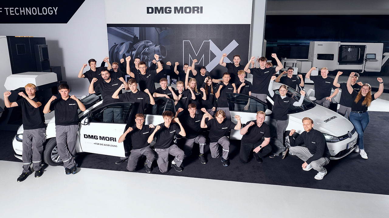 Das Bild zeigt eine Personengruppe die um zwei Autos herumsteht und die Hände zu Fäusten geballt in die Höhe streckt.