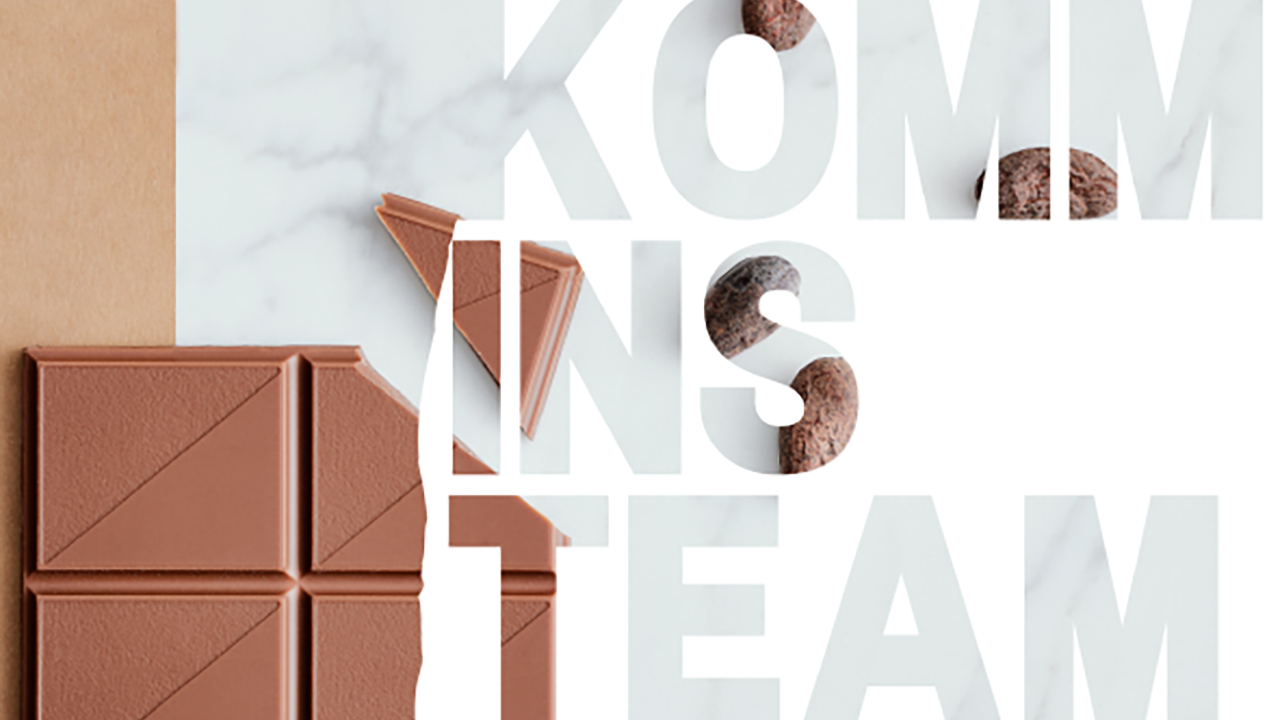 Das Bild zeigt eine Darstellung mit einer Schokolade und dem Spruch "KOMM INS TEAM"