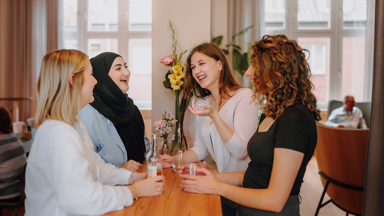 4 junge Frauen bei einer lebhaften Unterhaltung.