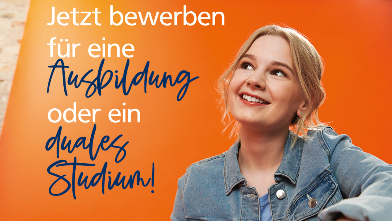 Junge Frau in Jeansjacke sitzt vor einem orangefarbenen Banner mit dem Schriftzug: Jetzt bewerben für eine Ausbildung oder ein duales Studium! Sie schaut lächelnd zu dem Slogan.