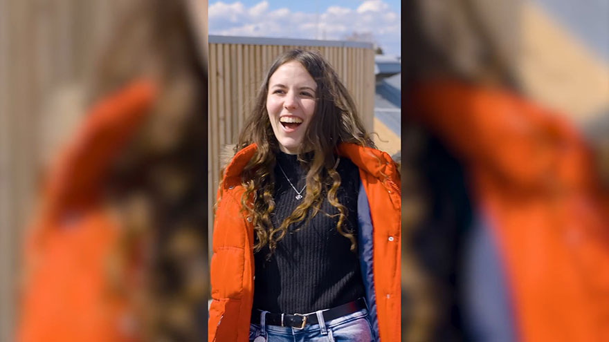 Junge Frau, lachend im Freien.